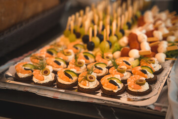 Close-up of canapes with cream cheese and shrimps served on a board