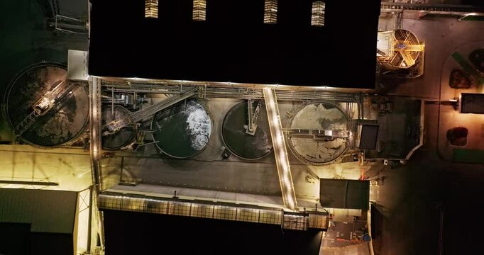 Metal Refinery Process Electrolysis Outdoor Large Liquid Containers Night Aerial Top Down Zoom Out