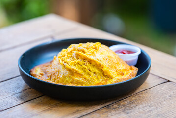 Omelet fried beaten eggs with minced pork on jasmin rice with chilli sauce,Thai traditional style.