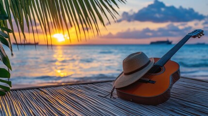 A serene sunset scene featuring a guitar and a hat on a beach.