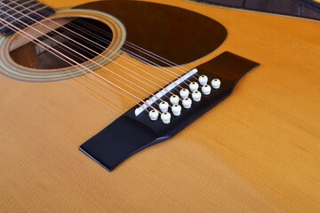 Fototapeta premium Musical instrument - Closeup fragment Vintage twelve-string acoustic guitar bridge