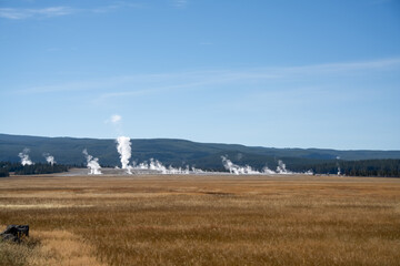 an active geyser spring with an intermittent discharge of water ejected turbulently and accompanied by steam