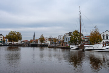 Delft, The Netherlands October 15, 2024. The harbour of Delft, with some old boats, and the skyline from the city.