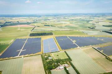 aerial view of solar panels and wind turbines