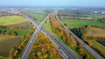 Aerial view on the A7 motorway in northern Germany between fields and meadows.