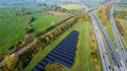 Aerial view on the A7 motorway in northern Germany between fields and meadows.