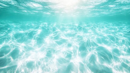 Obraz premium A serene underwater scene with sunlight creating beautiful patterns on the clear turquoise water surface, showcasing tranquility and natural splendor.