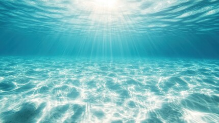 Obraz premium This stunning underwater image captures sunlight streaming through crystal-clear waters and creating mesmerizing patterns on a pristine sandy ocean floor.