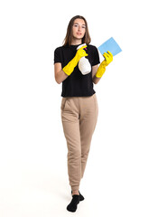 A young woman prepares to clean with a spray bottle and cloth, wearing yellow gloves in a bright and clean space