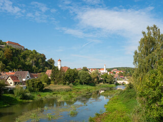 Fototapeta premium Harburg, Germany - September 29th 2023: View over the Woernitz river towards the town with the famous castle
