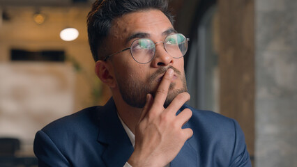 Thoughtful puzzled businessman Arabian Indian man thinking male guy employer worker think idea...