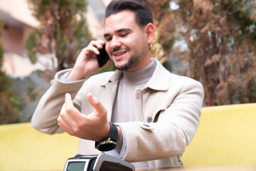 Man paying contactless with smartwatch