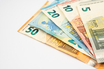 Euro banknotes isolated on white background. Euro cash background. Background from several euro paper cash. 