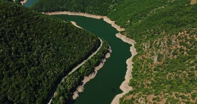 Cars Following Curved Mountain Road Natural Meandre River Body Fishing Zone Aerial Rise Reveal Opening Scene