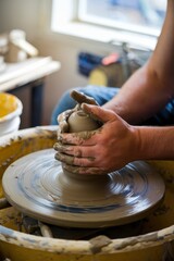 Close-up shot of hands sculpting clay on a potter's wheel.