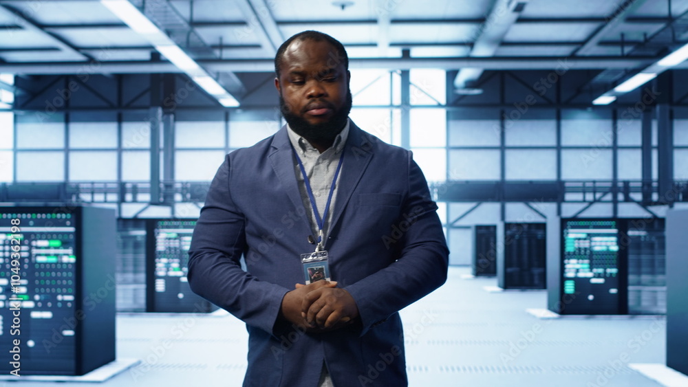Poster technician walking between server rows in data center, doing yearly infrastructure inspection. syste