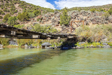 Old wooden bridge over the Rio Grand River in New Mexico, USA.