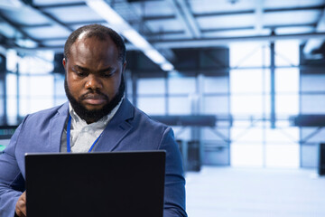 Data center engineer ensuring safety and security of database. Server room worker preventing...