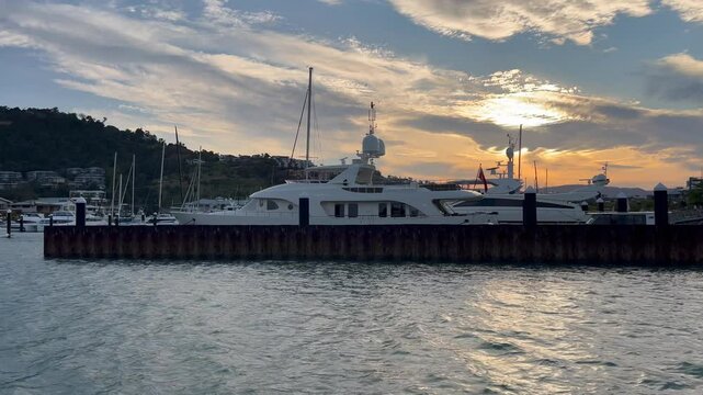 Dramatic sunset sky over Shute Harbour Marina Resort in Airlie Beach in the Whitsundays tropical north Queensland, Australia.