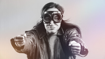 Biker woman with goggles holding handlebars and smiling