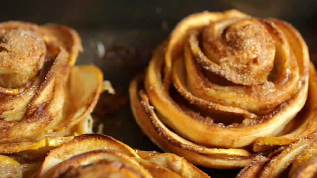 Baked puff pastry Apple Roses on a baking sheet tray. Close up.