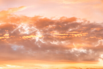 A beautiful sky tinted by the sun leaving vibrant shades of gold, pink, blue and multicolored. Clouds in the twilight evening and morning sky. Cloudy sky background in the evening, and during the day.