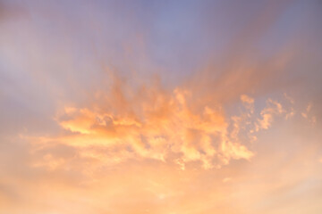 A beautiful sky tinted by the sun leaving vibrant shades of gold, pink, blue and multicolored. Clouds in the twilight evening and morning sky. Cloudy sky background in the evening, and during the day.