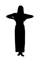 A woman in a long dress stands with her hands on her head