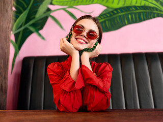 Trendy woman enjoying a tropical getaway at a colorful outdoor cafe