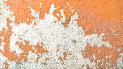 Empty old orange wall texture. Painted distressed wall surface. Grungy wide concrete wall. Grunge stonewall background. Shabby building facade with damaged plaster.