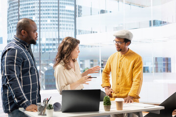 Business partners collaborating with a realtor contractor on office relocation, evaluating architectural plans of a high class building. Clients discussing real estate investment for a relocation.