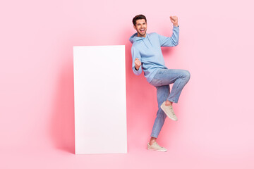 Full length photo of young guy excited winner bet online smartphone screen new parimatch gambling promo isolated on pastel pink color background