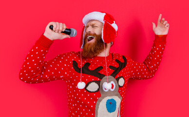 emotional man singing xmas music song. merry xmas. man singing xmas music isolated on red