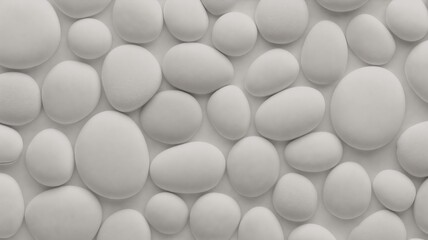 A close-up of smooth, white stones arranged in a random pattern.