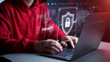 Person in red hoodie types on laptop with privacy and security icons displayed.