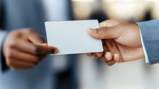 Business Card Exchange: Close-up shot of two businesspeople exchanging a blank business card.  A moment of connection and networking.