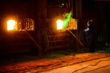 Reverberatory furnace melts copper metal with burning flame