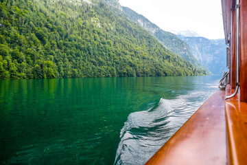 Sunlit peaks and tranquil green waters view from boat