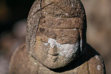A small praying monk statue at Hase Dera Temple in Kamakura.