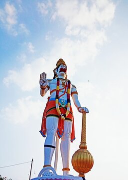 Statue of lord Hanuman under cloudy sky