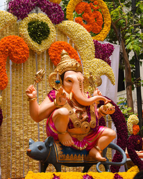 Statue of lord Ganesha decorated with yellow flower