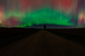 Green aurora in the sky in a rural setting