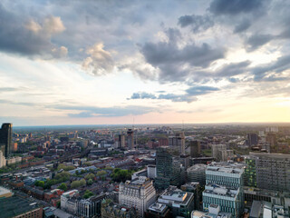 Fototapeta premium Aerial View of Greater Manchester City Centre and Tall Buildings During Golden Hour of Sunset, England UK. High Angle View Was Captured with Drone's Camera on the day of May 5th, 2024