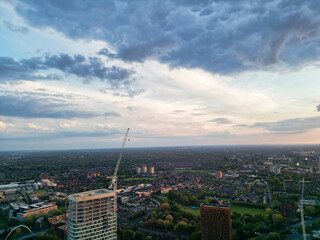 Fototapeta premium Aerial View of Greater Manchester City Centre and Tall Buildings During Golden Hour of Sunset, England UK. High Angle View Was Captured with Drone's Camera on the day of May 5th, 2024