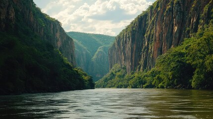 Fototapeta premium Dramatic River Canyon with Steep Cliffs and Lush Greenery