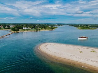 Antique boat sailing around Sandy Point, a sandspit harbor in Stonington, Connecticut, United...