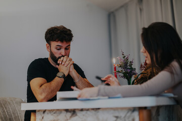 A university student engages attentively during a personal class session with a professor at home. The setting is relaxed and focused, indicating a personalized learning environment.