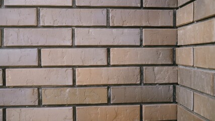 Camera gliding along the corner of a textured brick wall