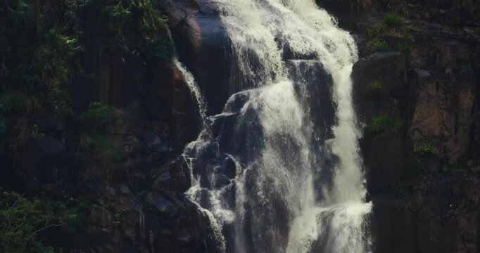 Detailed footage of Kuda Ravana Ella waterfall pouring over rugged rocks, highlighting the powerful flow and natural beauty of Sri Lanka s landscapes. Ideal for nature and adventure content.