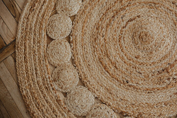Natural woven jute rug displayed on a wooden floor with circular patterns for home decor
